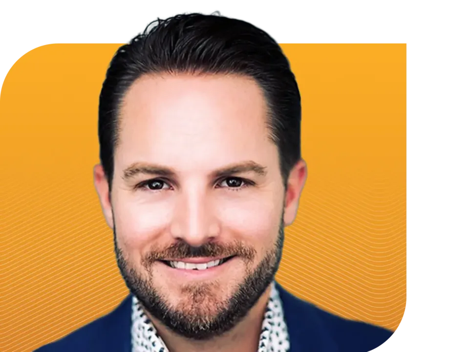 Professional headshot of a smiling man with a beard in a blue suit jacket against a yellow background with wavy white lines.