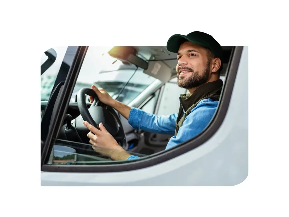 Truck driver using a mobile device with Yard Visit Portal appointment booking interface for TMS-integrated yard scheduling.