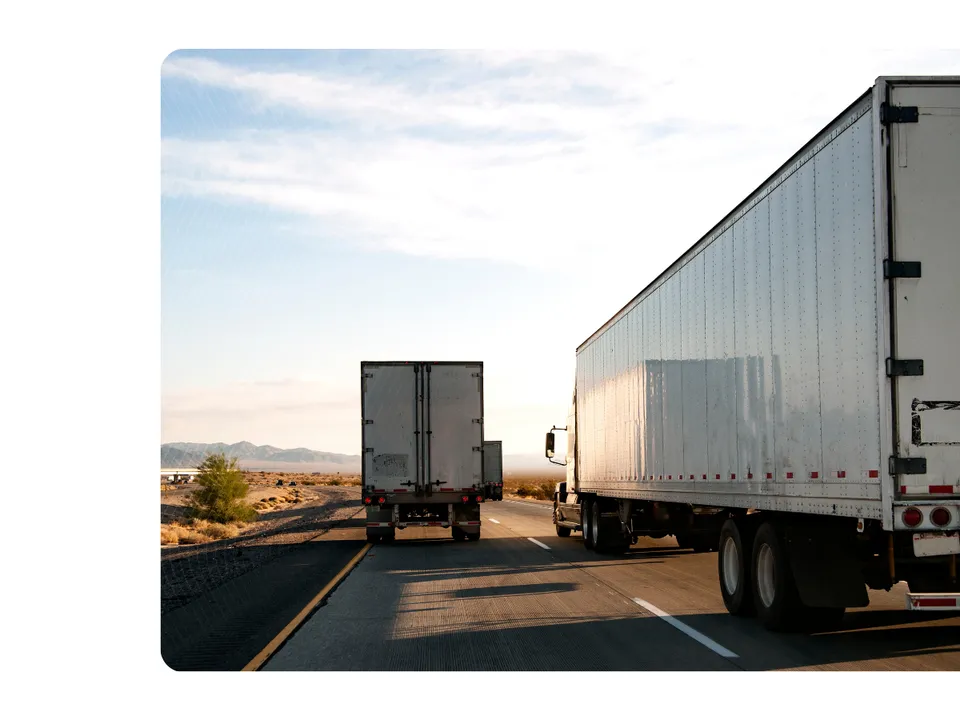 Freight trucks on highway for procurement continuum webinar on shipper transportation strategy