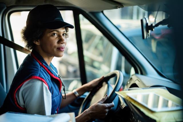 Woman smiling inside a semi cab
