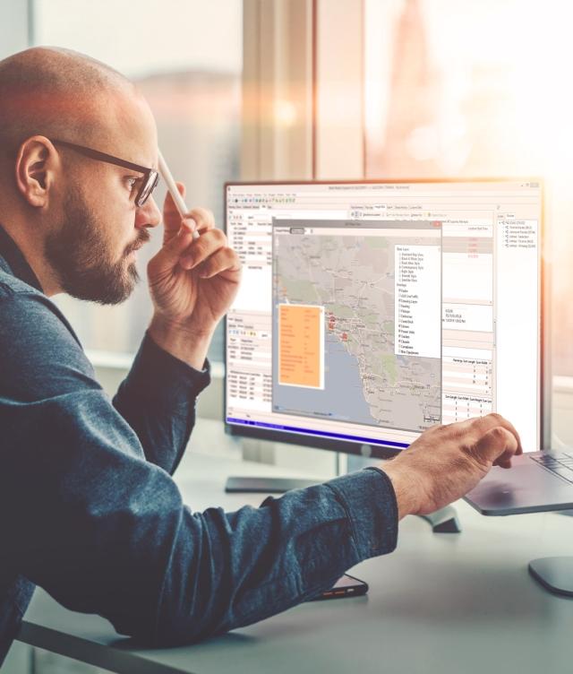 Man in Dispatch Office using Trimble TruckMate TMS
