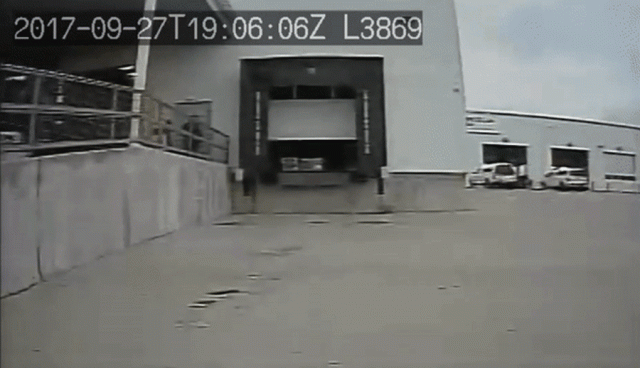 A truck backing up into a loading station