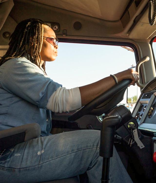 Side view of woman driving truck