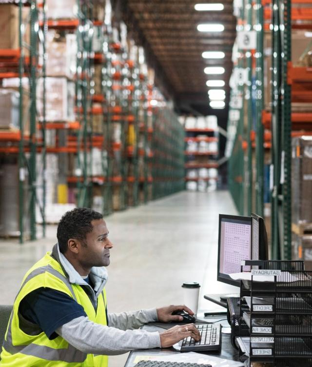 checking spot rates in warehouse on computer