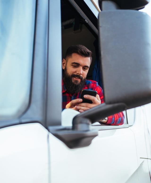 driver in cab on phone