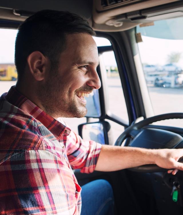 Smiling truck driver in cab