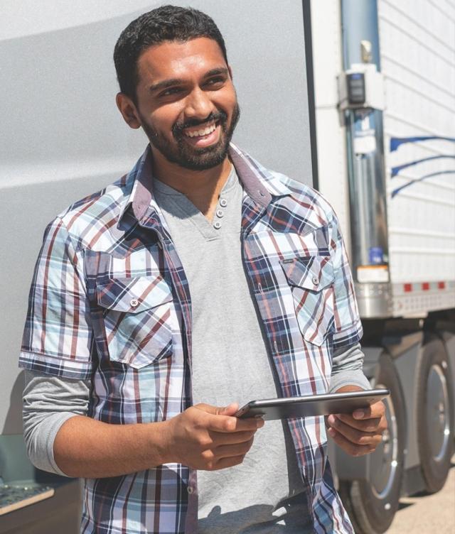 Man Outside of Truck With Tablet