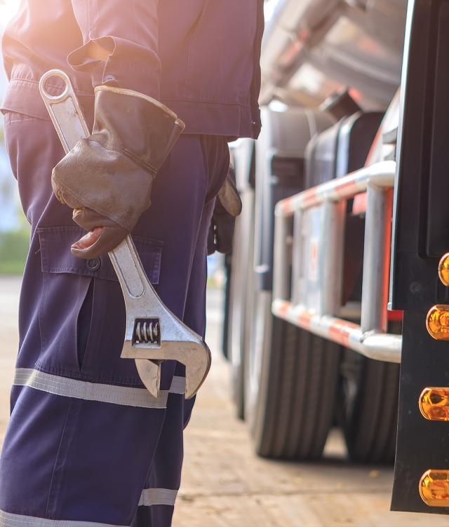 mechanic standing next to truck