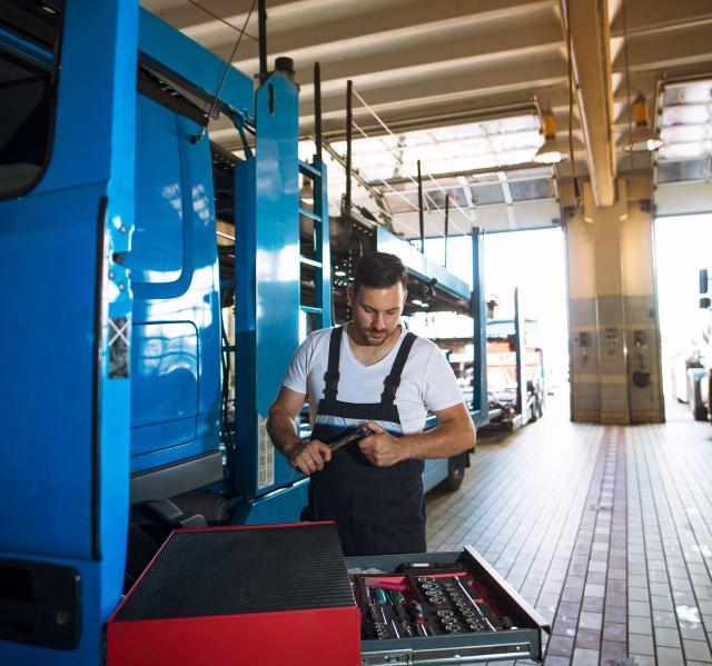 mechanic with tool chest in service center garage