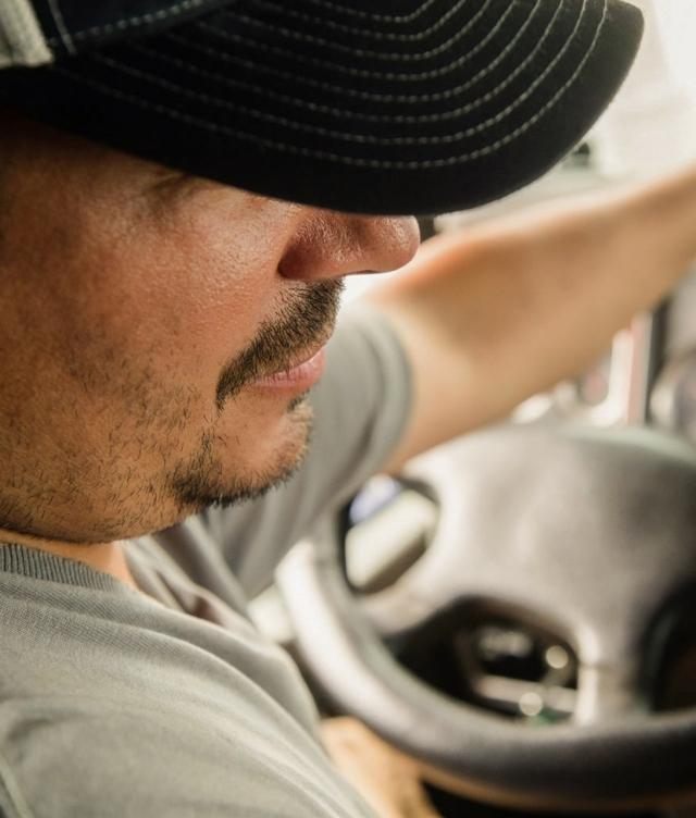 truck driver in cab over shoulder