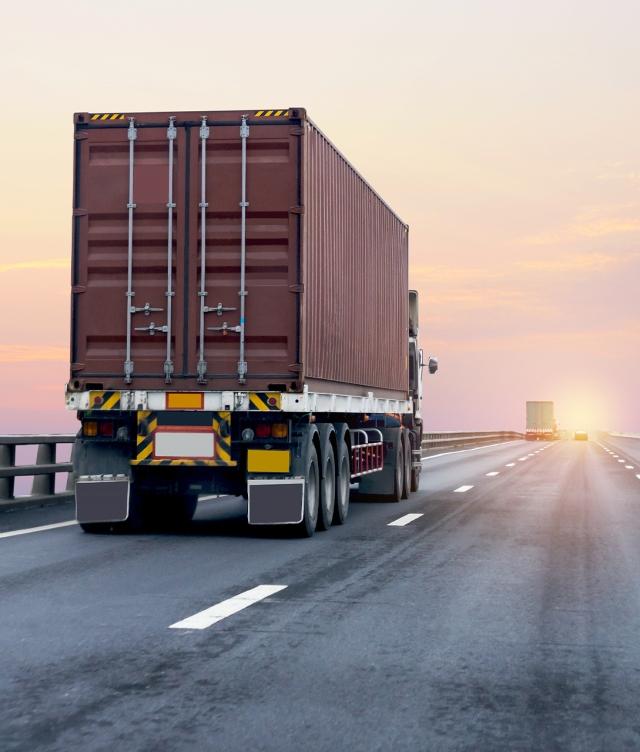 truck driving into sunrise
