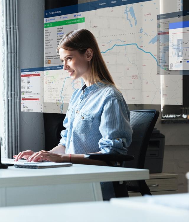 Woman checking status of loads using Trimble Visibility