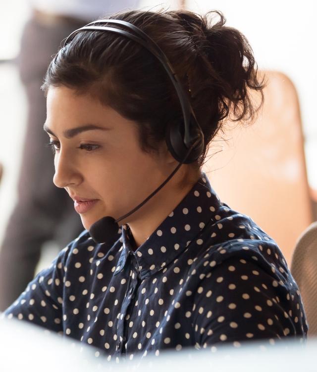 Woman on headset in dispatch office