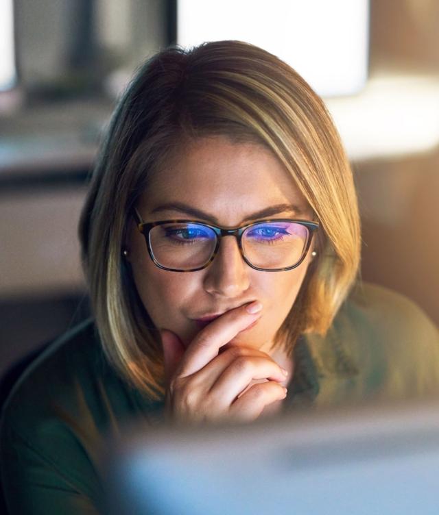 Woman Examining Computer Screen