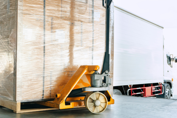 Shipment pallet and semi trailer truck at the end of a loading dock 