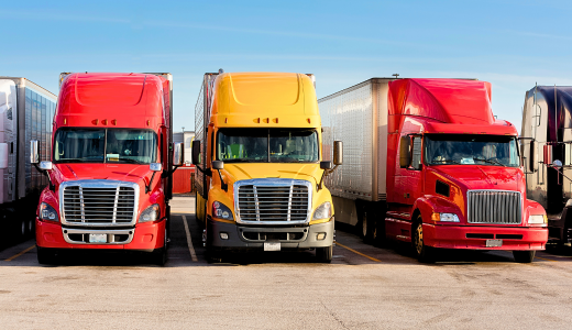 Semi trucks waiting to unload and load at warehouse dark and yard